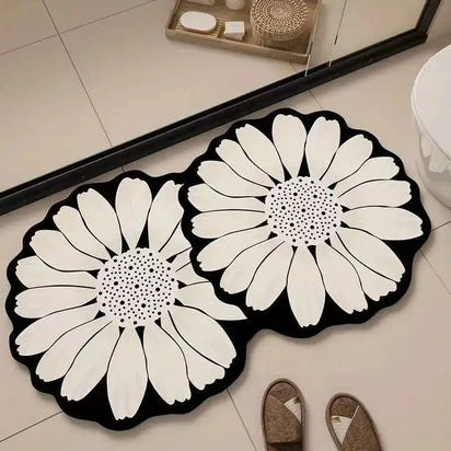 Black and white daisy-shaped bath mats.