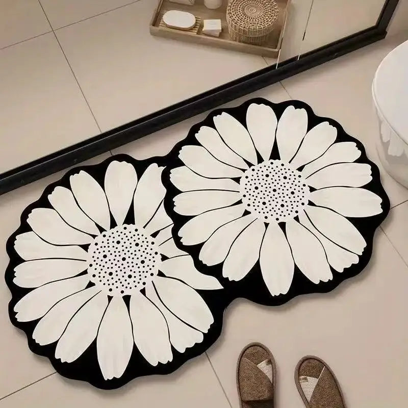 Black and white daisy-shaped bath mats.