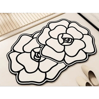 Floral-shaped, black and white rugs.