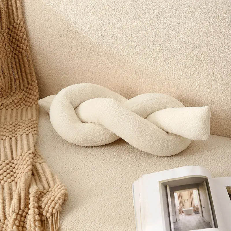 Cream-colored knot pillow.