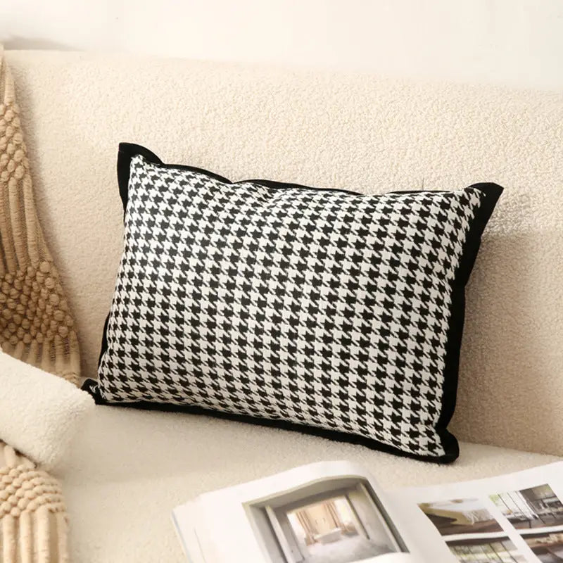 Houndstooth patterned pillow with black trim.