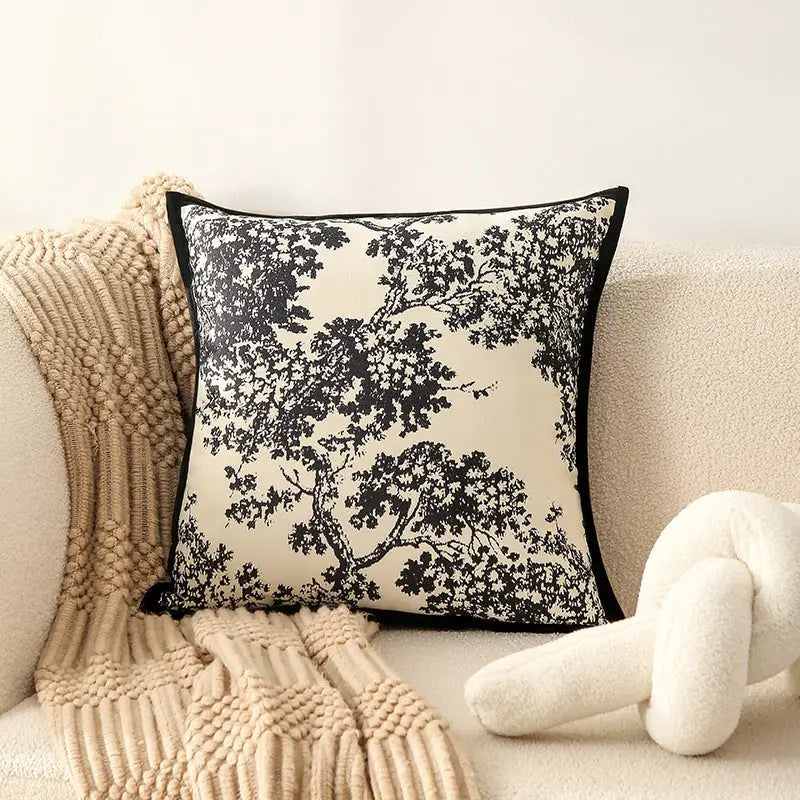 Black and white tree-patterned pillow.