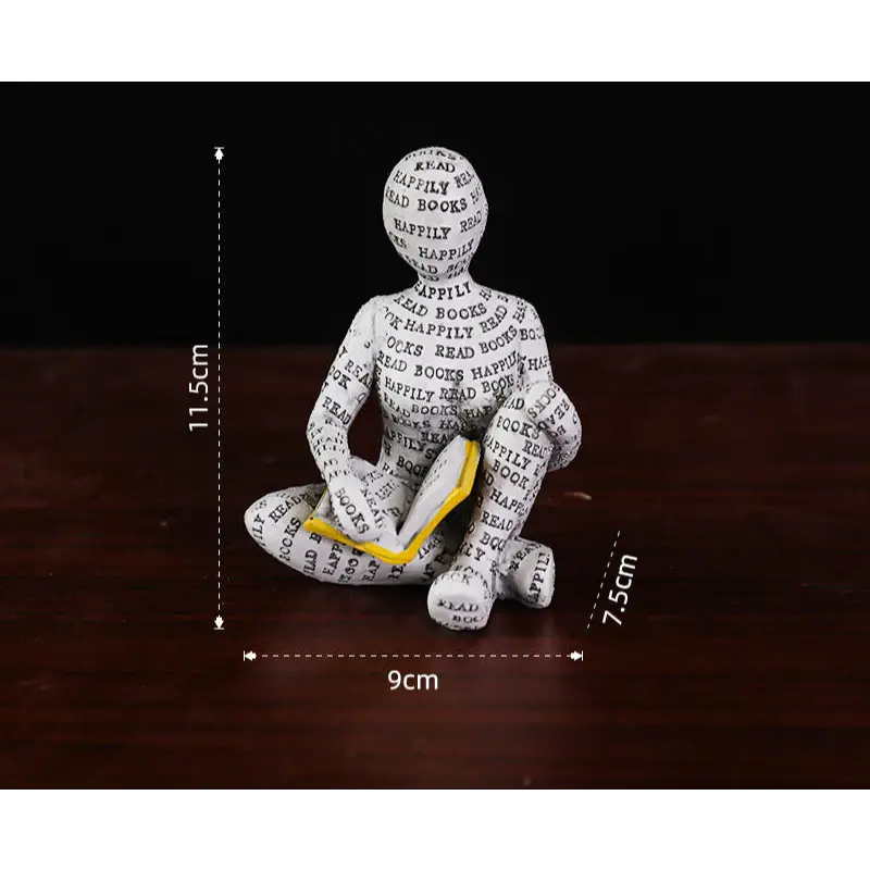 Figurine of a person reading a book.