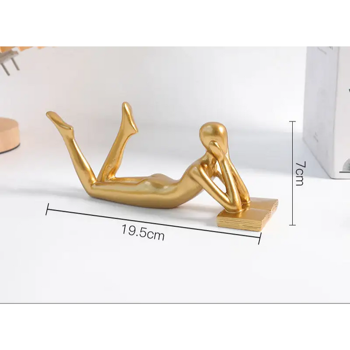 Golden reclining figure sculpture.