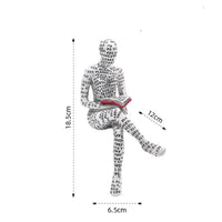 Seated figure covered in text reading a book.