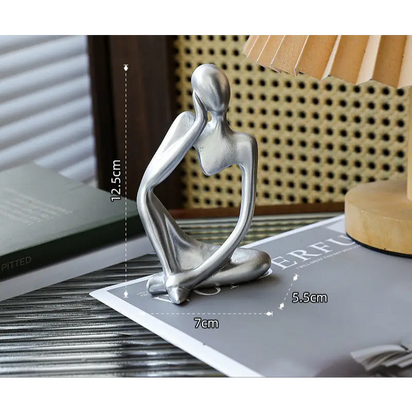 Silver abstract thinker sculpture.