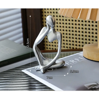 Silver abstract thinker sculpture.