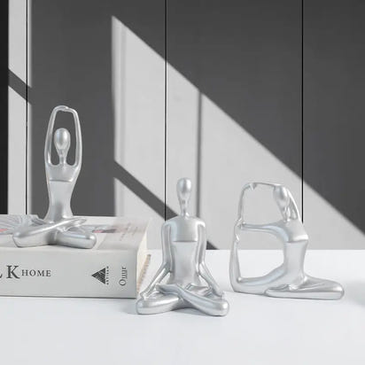 Silver yoga figurines.
