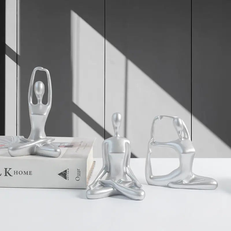 Silver yoga figurines.