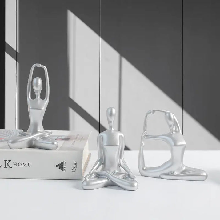 Silver yoga figurines.