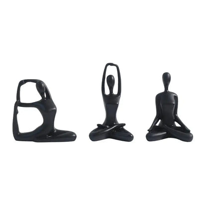 Three black yoga figurines.