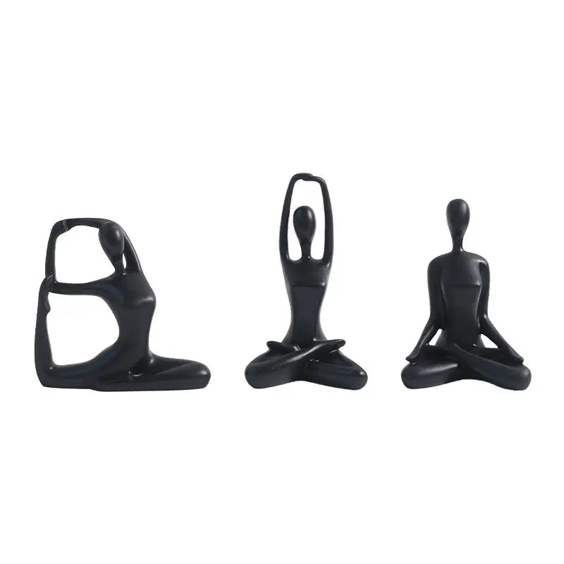 Three black yoga figurines.