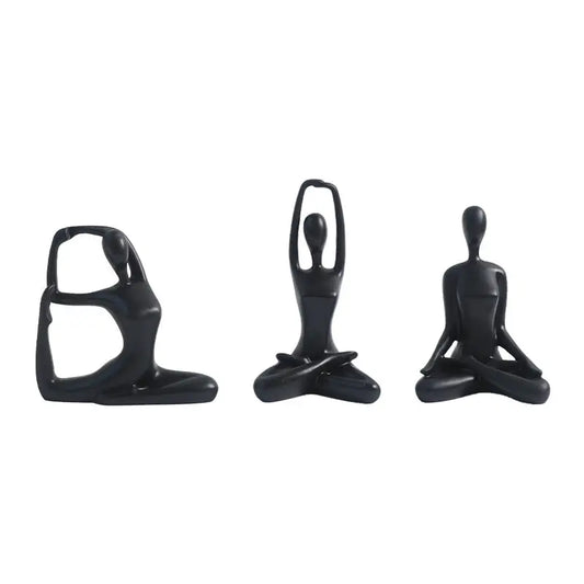 Three black yoga figurines.