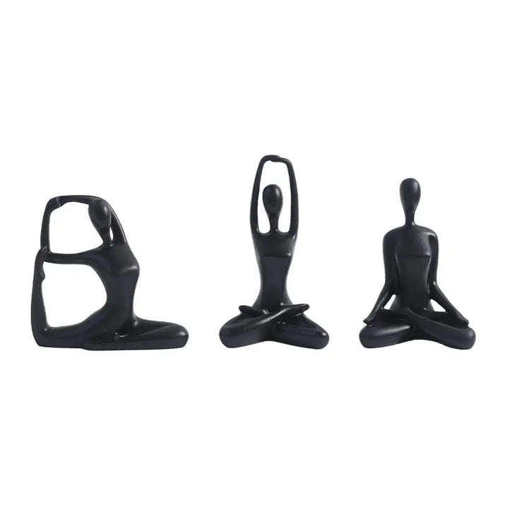 Three black yoga figurines.
