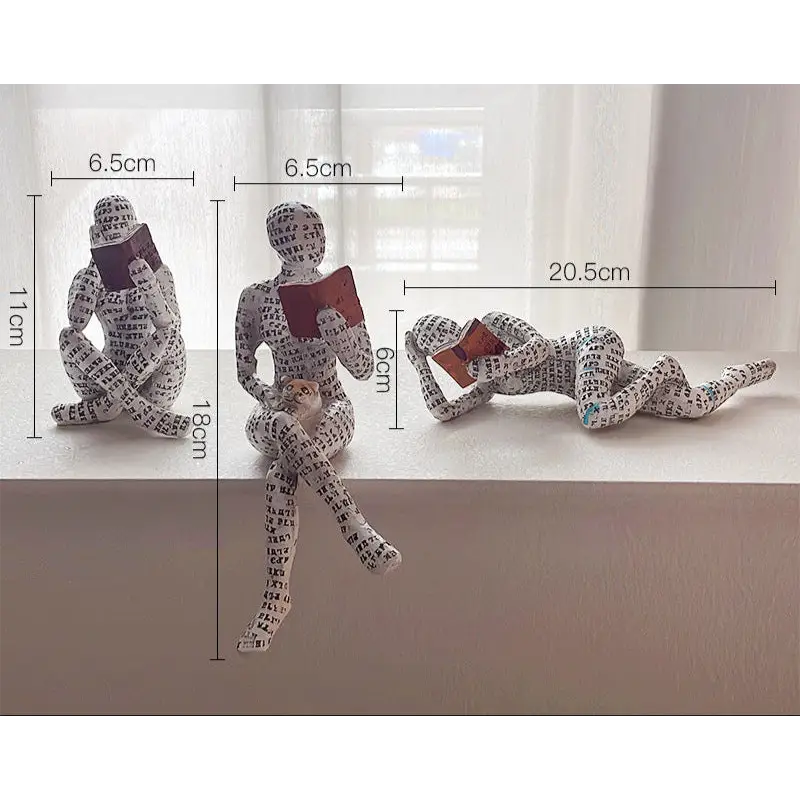 Three reading figure sculptures.