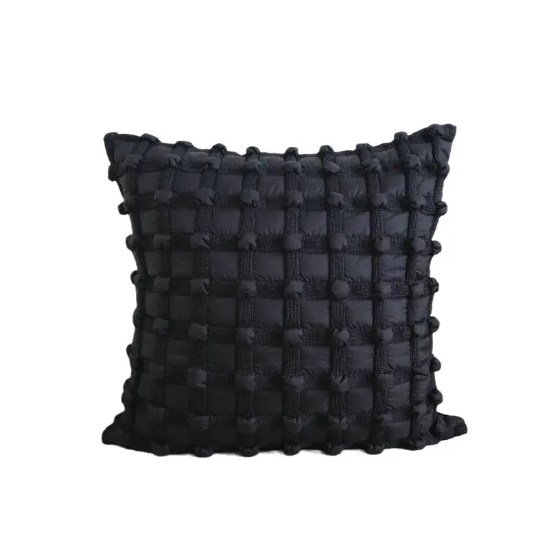 Black textured throw pillow.