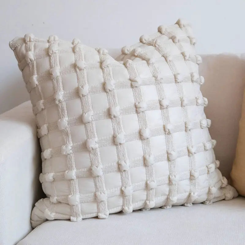 Textured white decorative pillow.