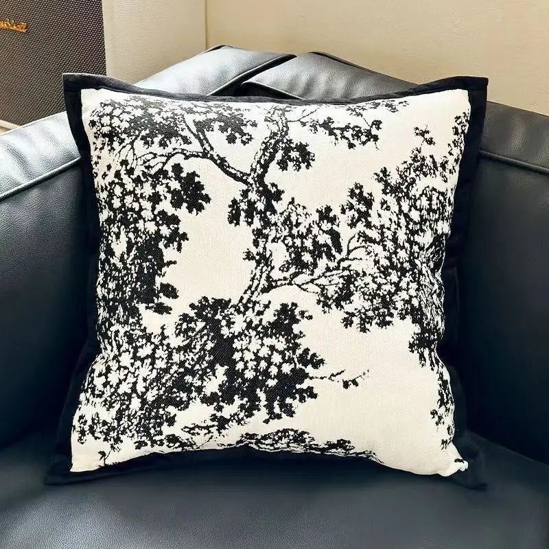 Black and white tree-patterned pillow.