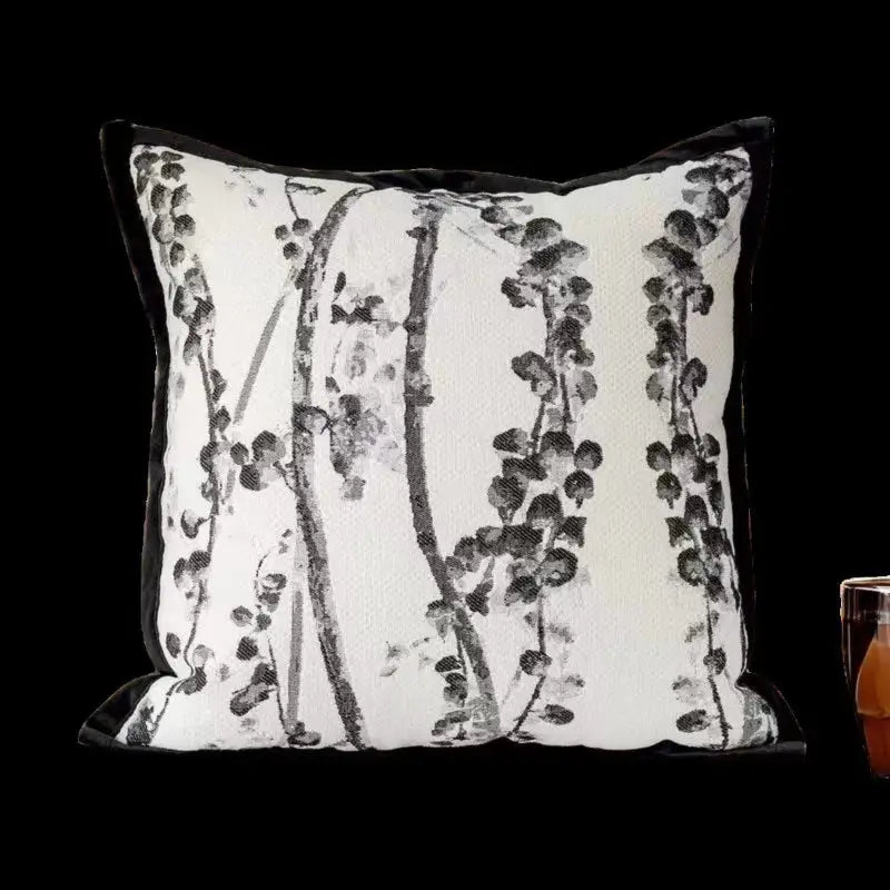 Floral-patterned decorative pillow with black trim.