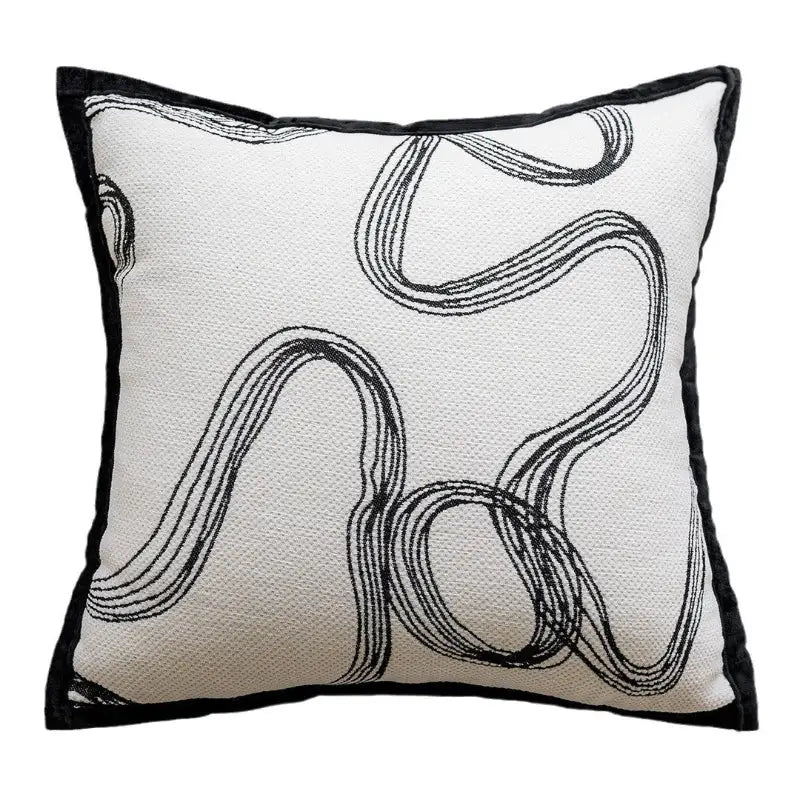 Square throw pillow with black line design.
