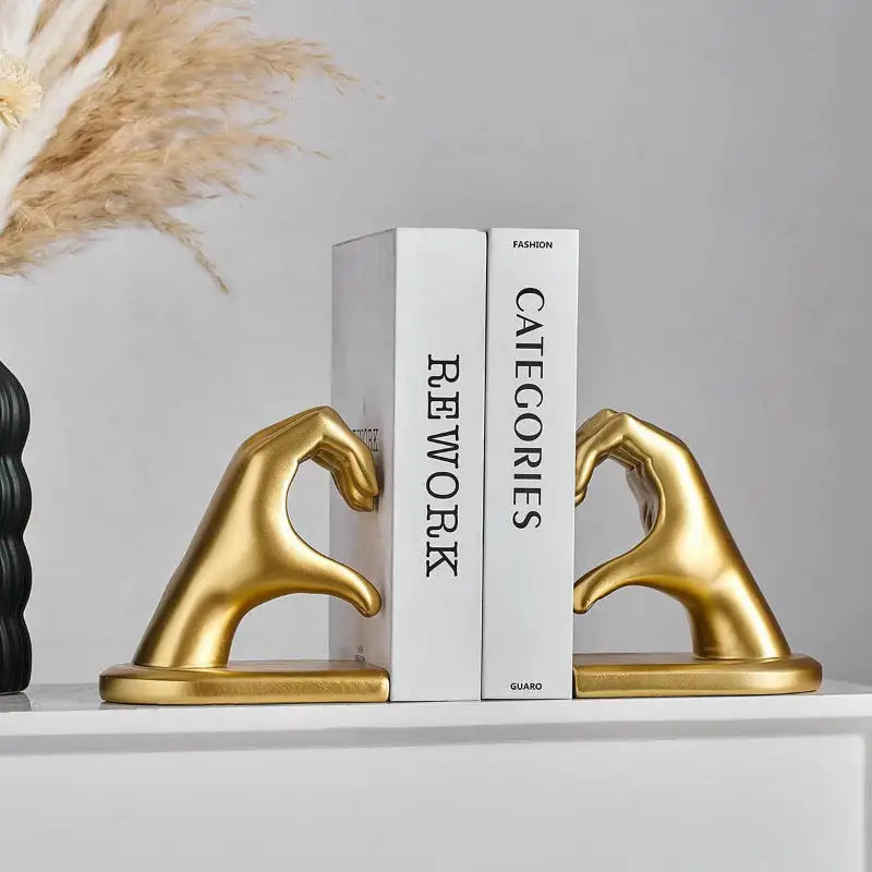 Gold hand-shaped bookends.