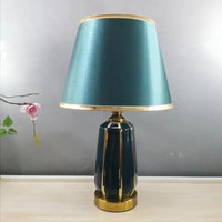 Teal and gold table lamp.