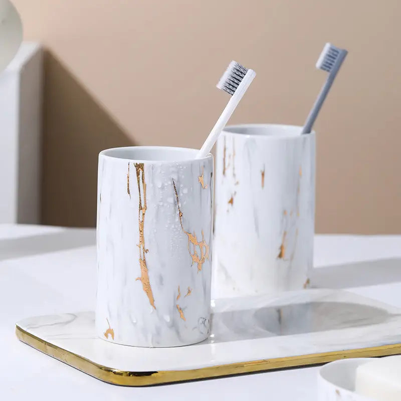 Marble-patterned toothbrush holders with toothbrushes.
