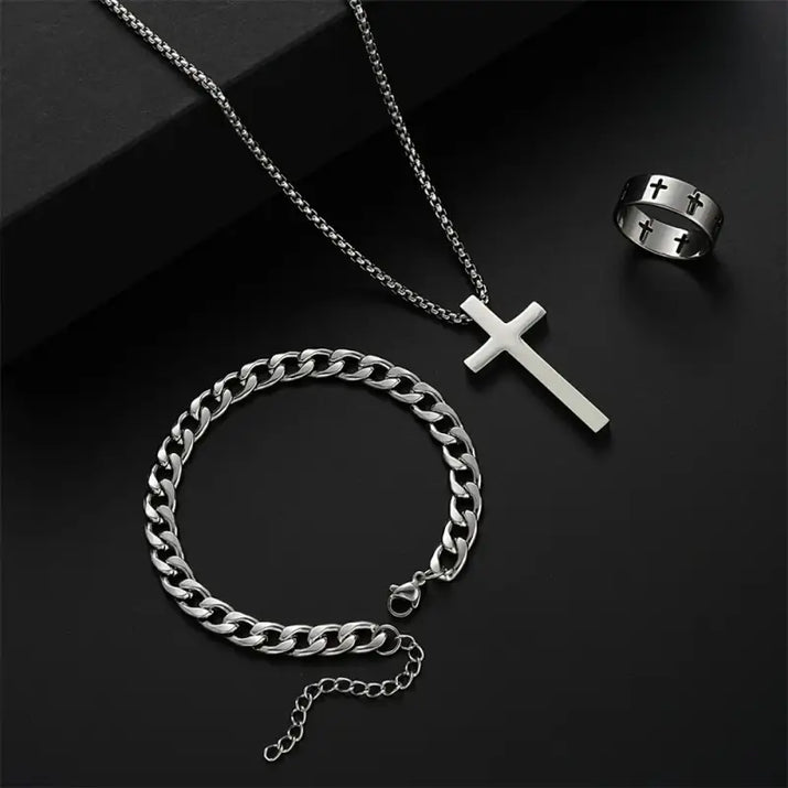 Silver cross necklace, chain bracelet, and cross ring.