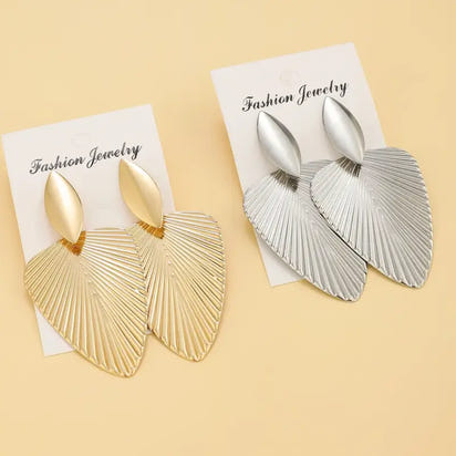 Gold and silver leaf-shaped earrings.