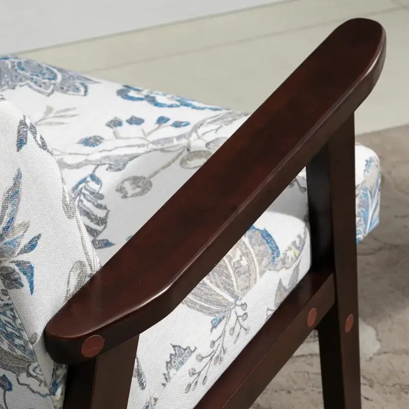 Floral upholstered modern accent chair with wooden armrest in mid-century modern style