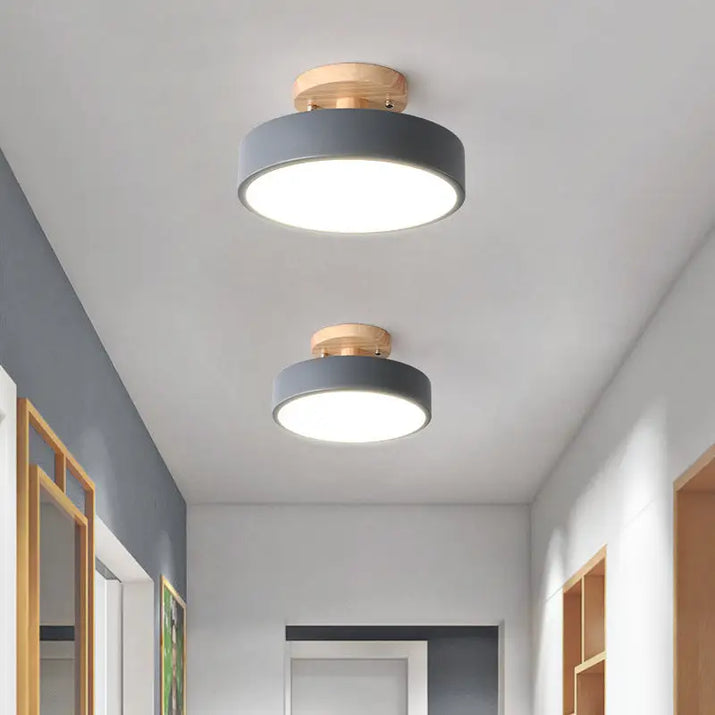 Two gray and wood ceiling lights.