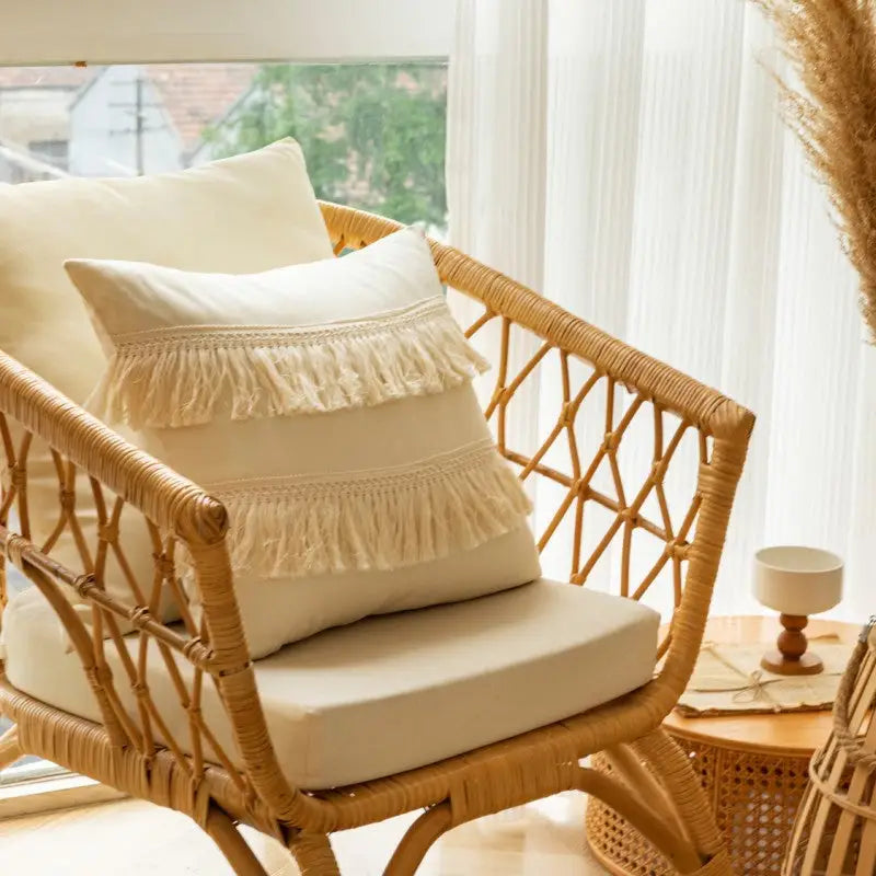 Wicker chair with colorful fringed pillow from Morocco Style Home Throw Pillow collection