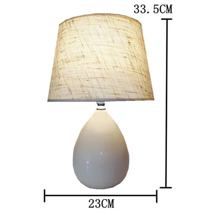 White teardrop lamp with linen shade.