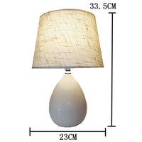 White teardrop lamp with linen shade.