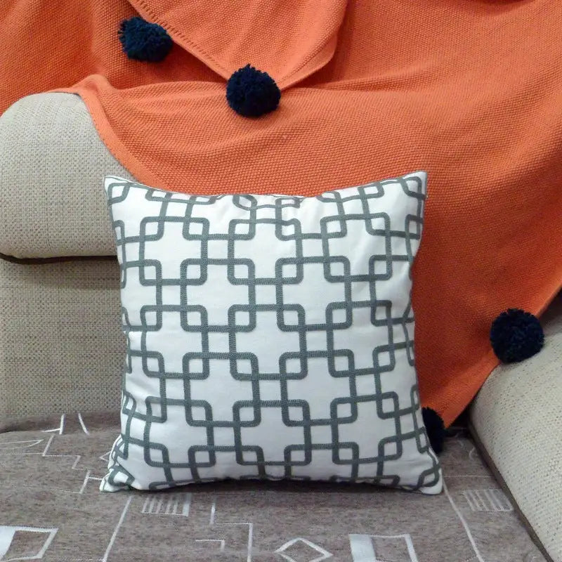 Square pillow with gray geometric pattern.