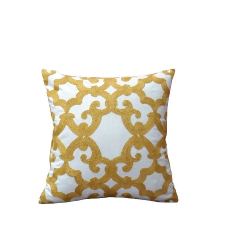 Decorative throw pillow with gold pattern.