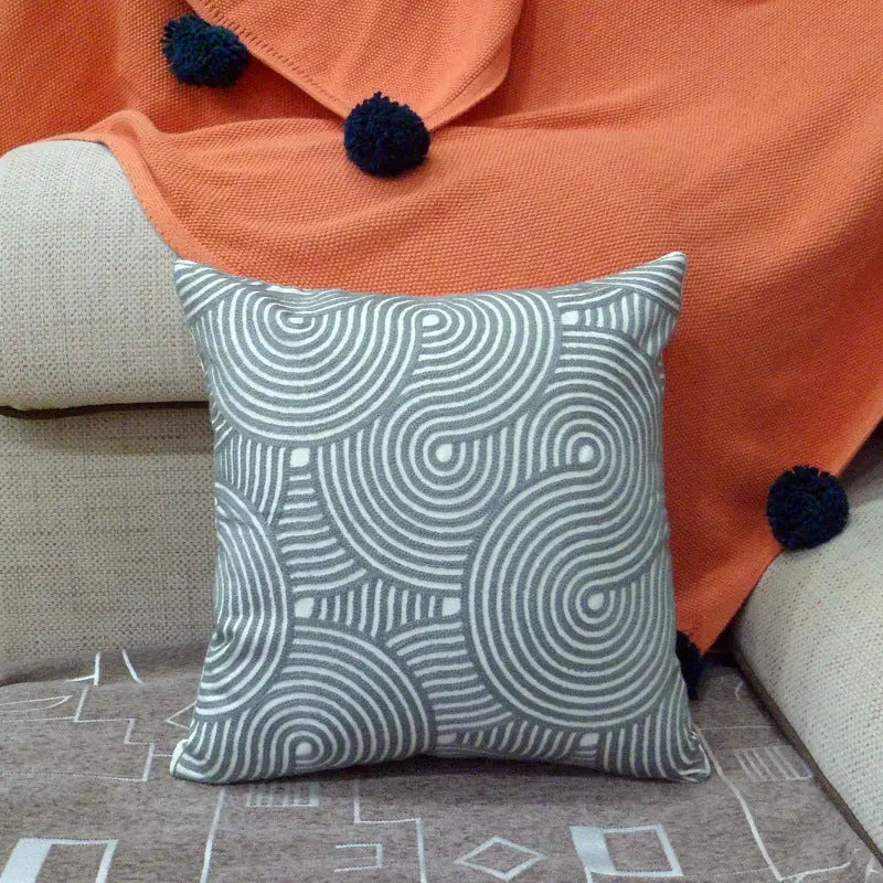 Gray and white patterned throw pillow.