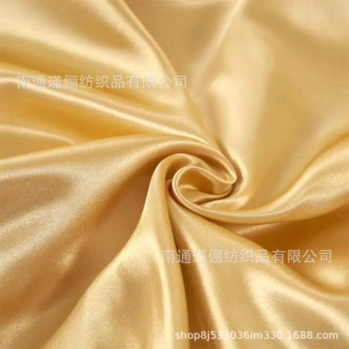 Golden, shimmering satin fabric.
