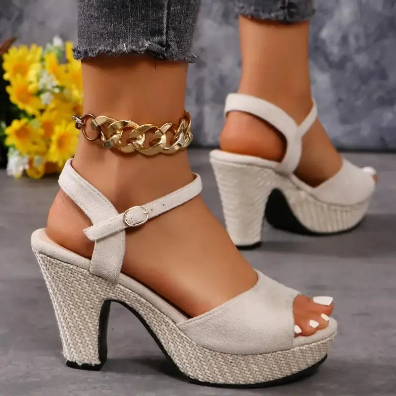 Beige platform sandals with ankle strap.