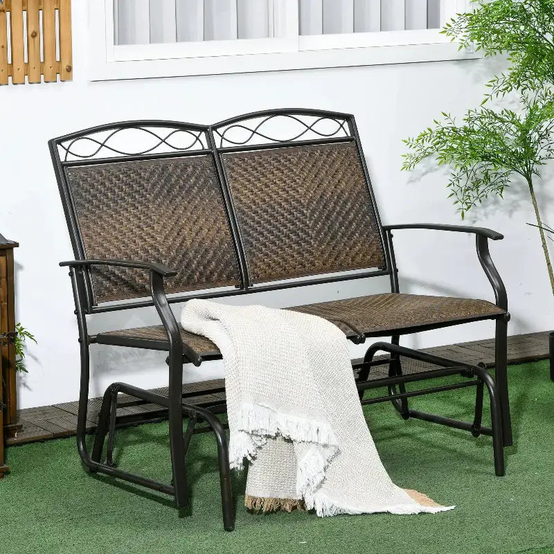 Outdoor glider loveseat with throw blanket for cozy outdoor seating comfort