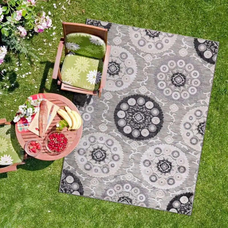 Gray patterned outdoor rug featuring Nordic geometric foliage and tropical plant patio design