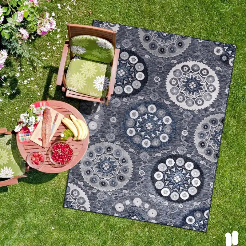 Patterned outdoor rug with Nordic geometric foliage tropical plant patio design