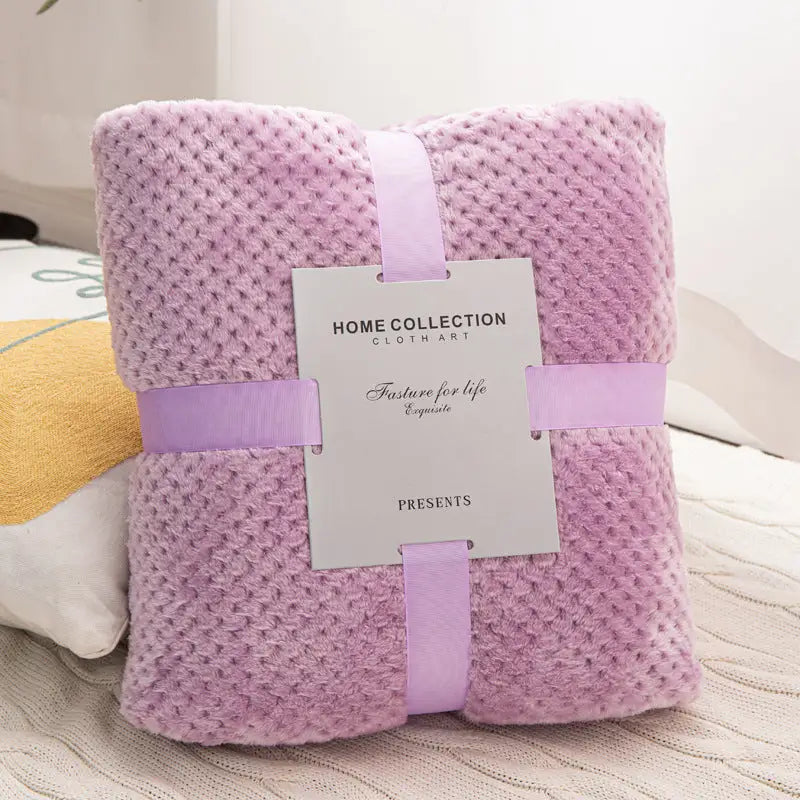 Lavender textured blanket with ribbon and tag.