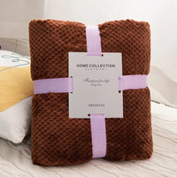 Brown textured blanket with lavender ribbon.