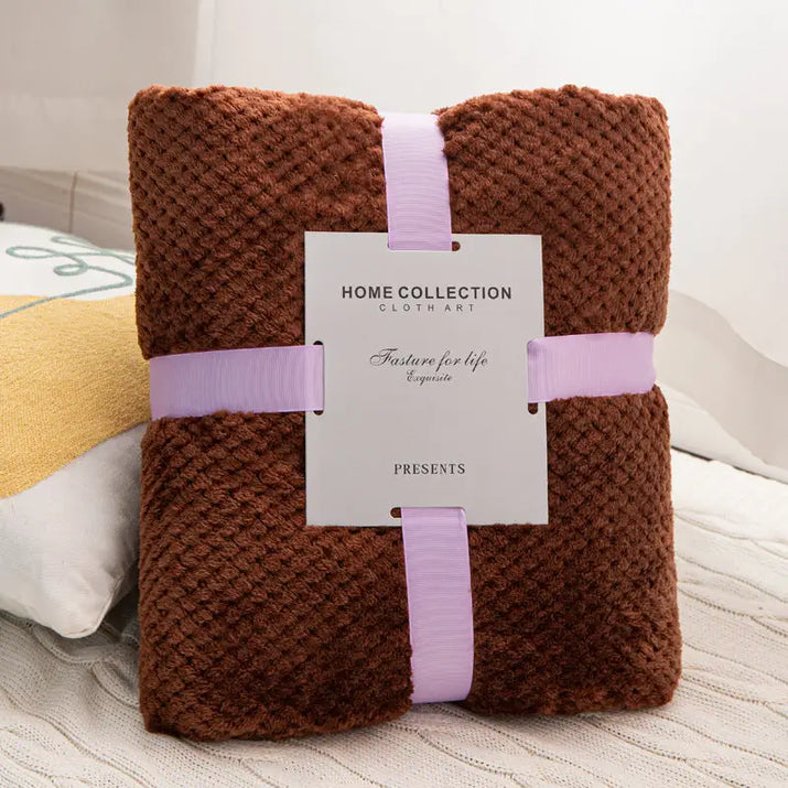 Brown textured blanket with lavender ribbon.