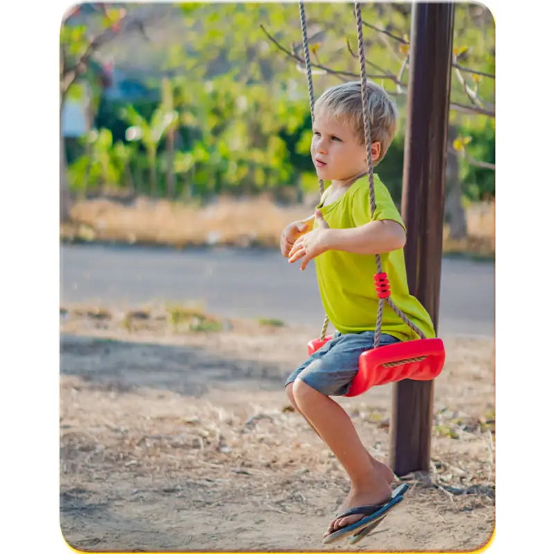 Child enjoying a red kids curved swing on outdoor kids curved playground equipment