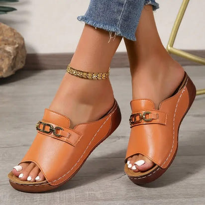 Women’s tan leather playfully stylish sandals with metal buckle accents and platform design