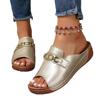 Metallic gold slide sandals with metal buckle accents and platform design for playfully stylish footwear