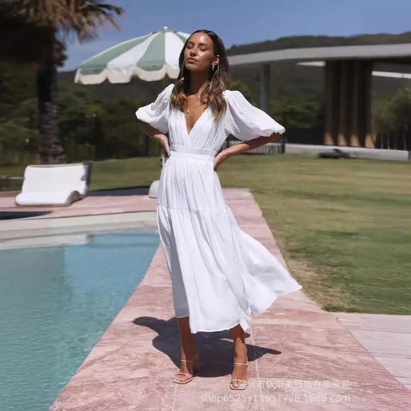 White, v-neck, puff-sleeved dress.