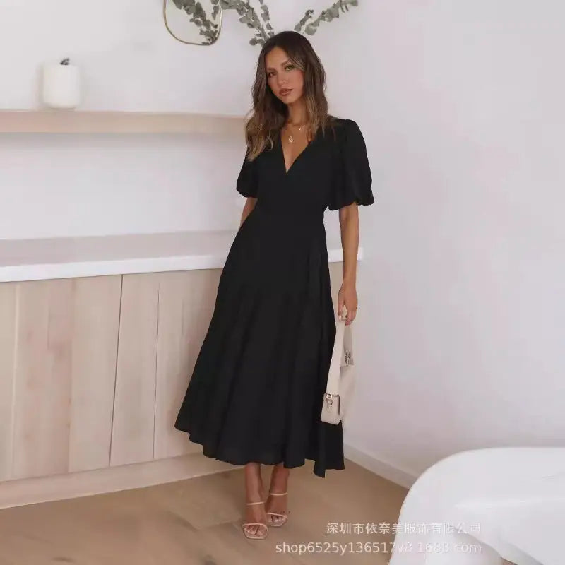 Woman in a black midi dress.